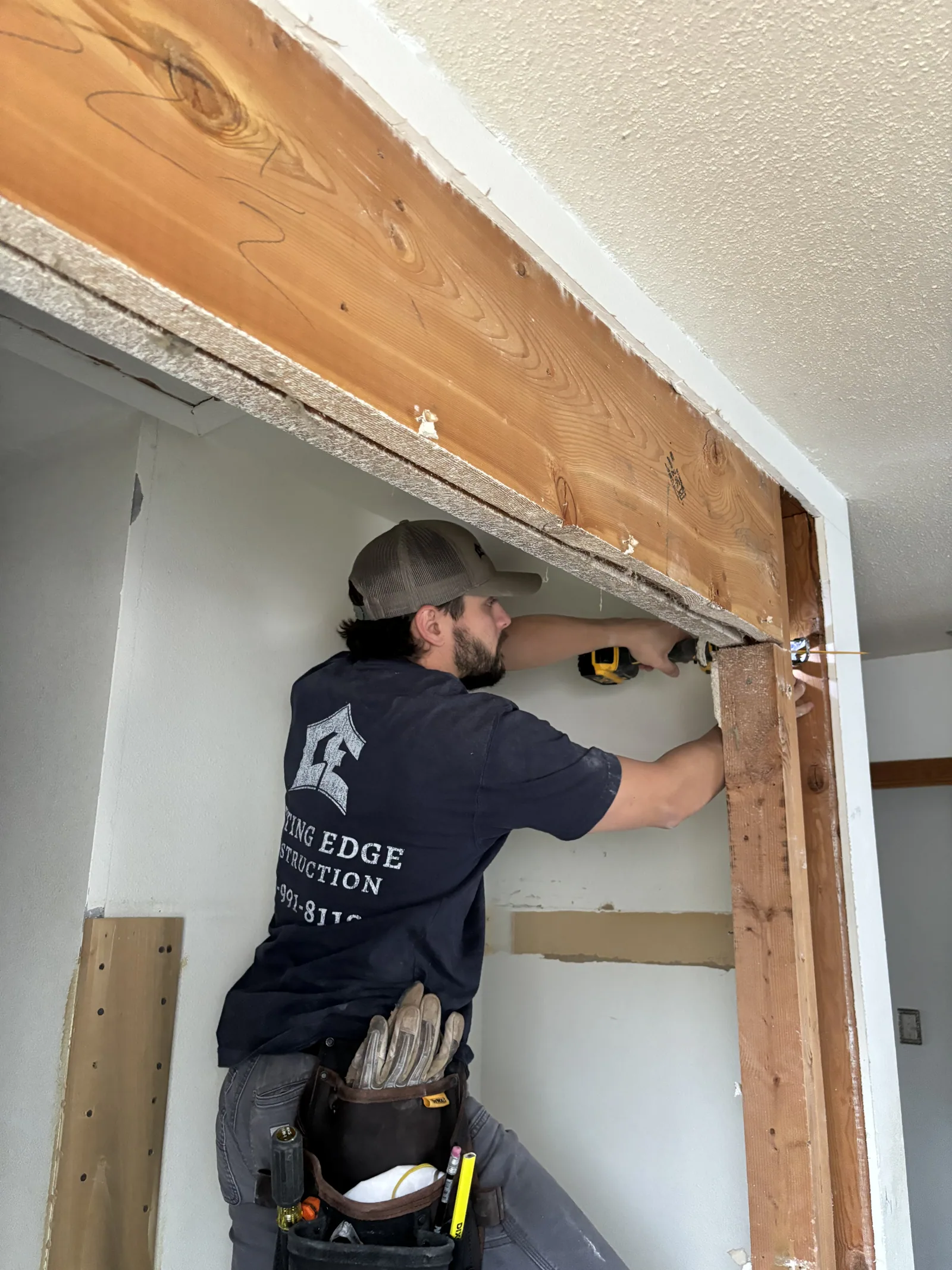 Cutting Edge crew member working on an interior doorway