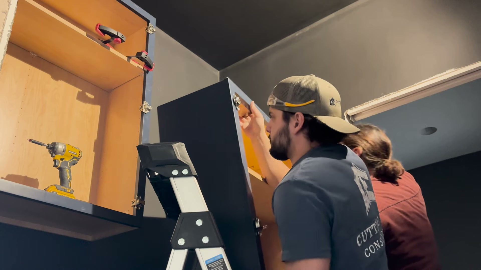 Cutting Edge carpenters fitting kitchen cabinetry together